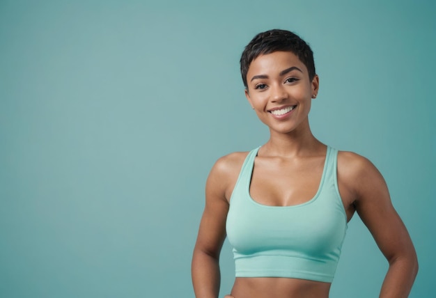 A cheerful woman in a sports bra exudes energy and positivity hands on her waist and ready for