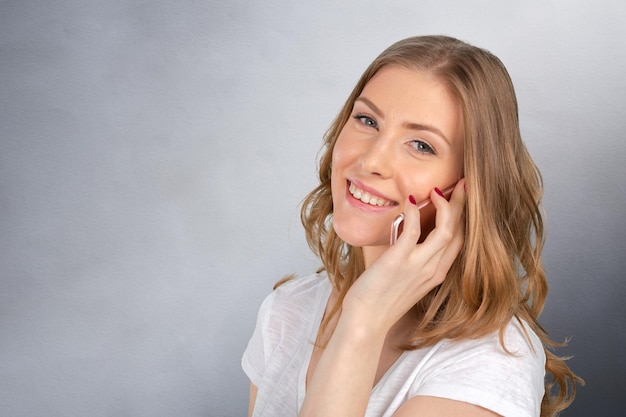 Cheerful woman talking on the phone isolated