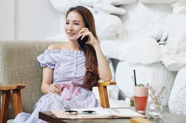 Cheerful woman talking on phone