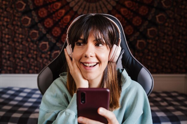 Photo cheerful woman talking on video call at home