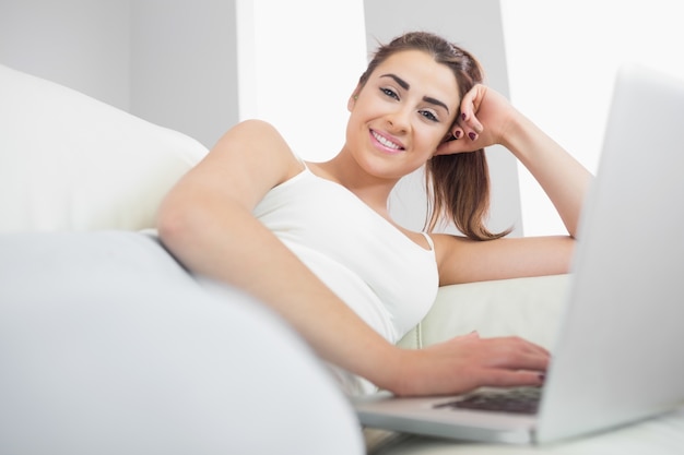 Cheerful woman using her notebook