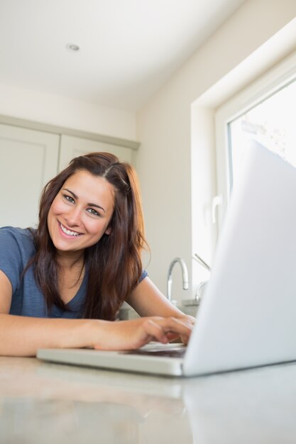 Cheerful woman using laptop