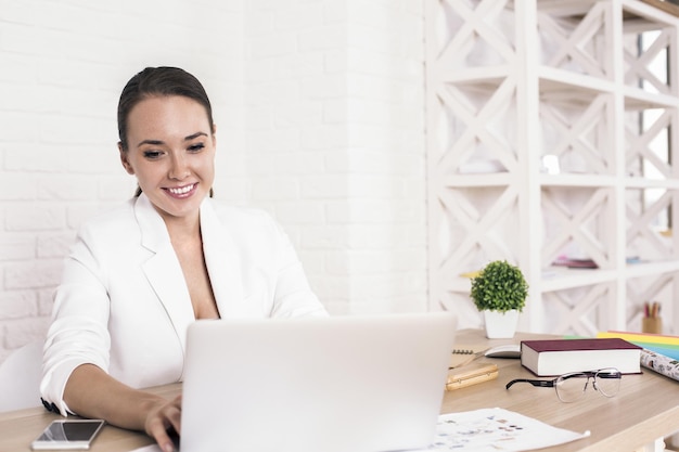 Cheerful woman using laptop