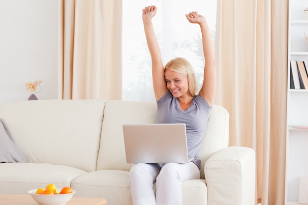 Cheerful woman using a notebook