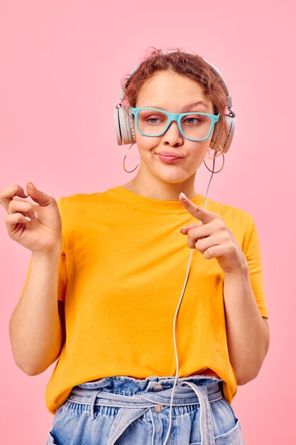 Cheerful woman wearing headphones blue glasses close-up emotions lifestyle unaltered