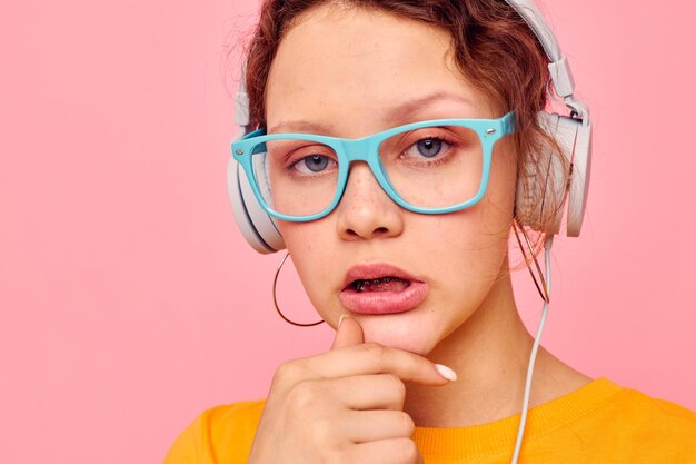 Cheerful woman wearing headphones blue glasses closeup emotions cropped view unaltered