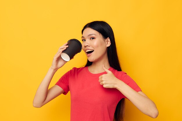 Cheerful woman with black glass of drink posing