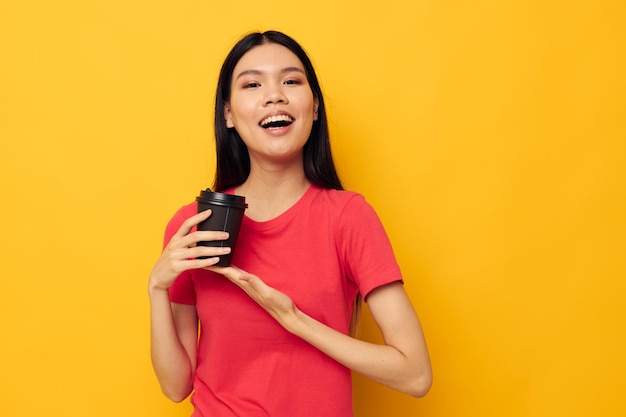 Cheerful woman with black glass of drink posing