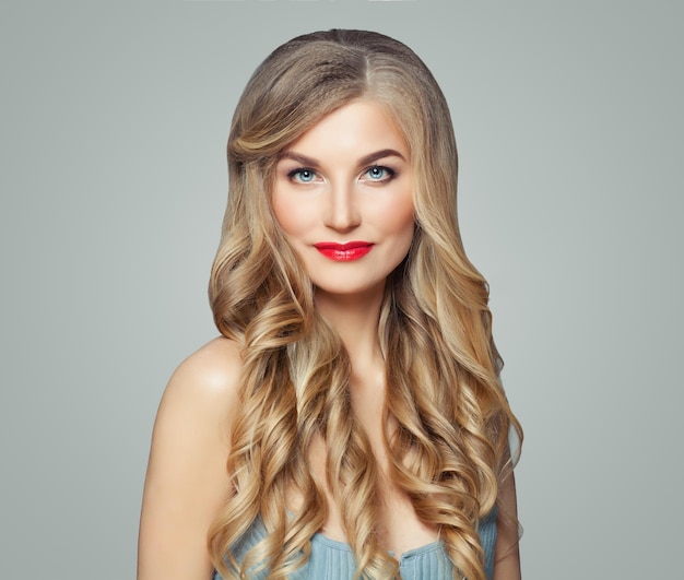 Cheerful woman with healthy curly hairstyle and red lips makeup Facial treatment haircare and cosmetology