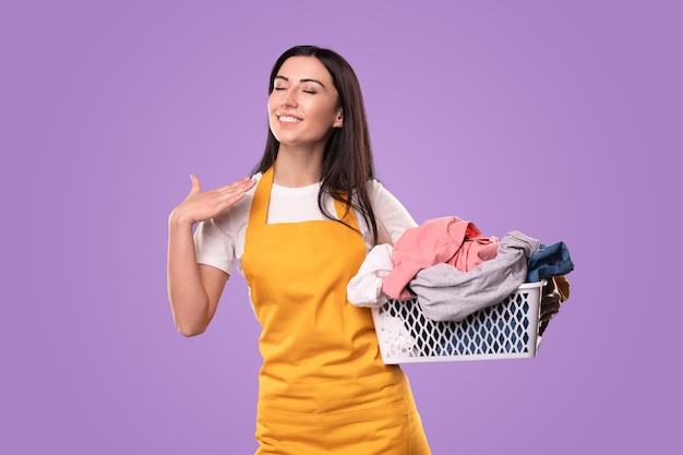 Cheerful woman with laundry basket