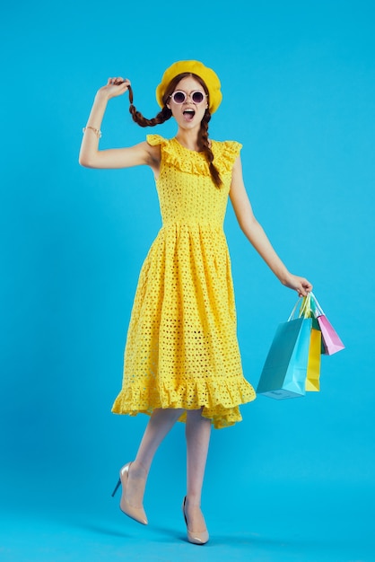 Cheerful woman with multicolored bags posing isolated background