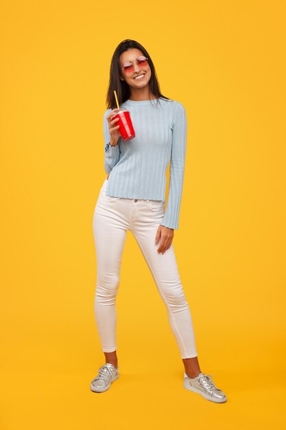 Cheerful woman with plastic cup