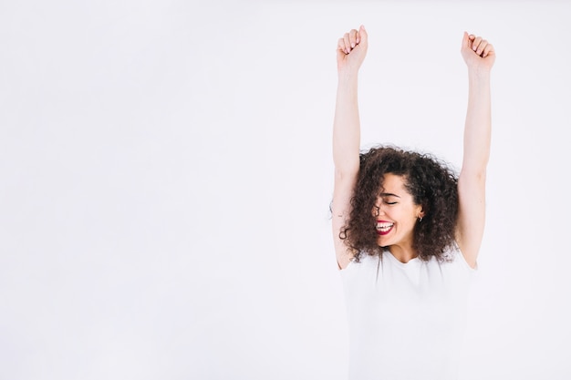 Cheerful woman with raised arms