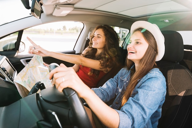 Cheerful women driving car