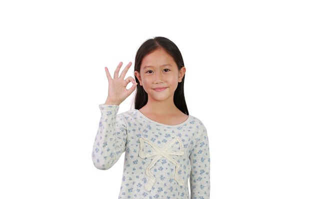 Cheerful young Asian girl kid showing finger ok symbol sign language isolated on white background