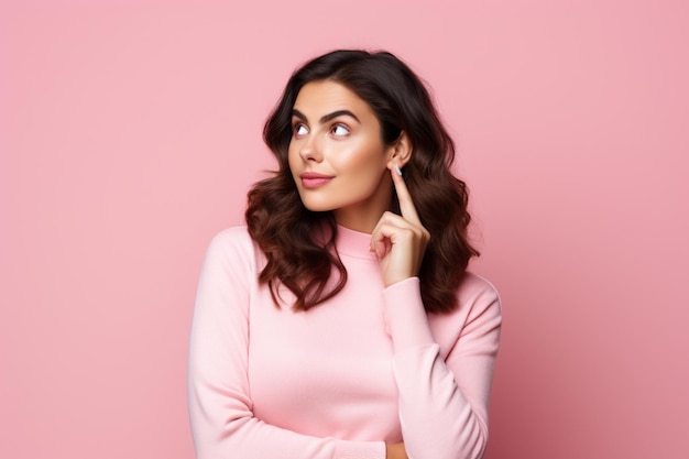 Cheerful young beautiful and stylish female model posing against pink background