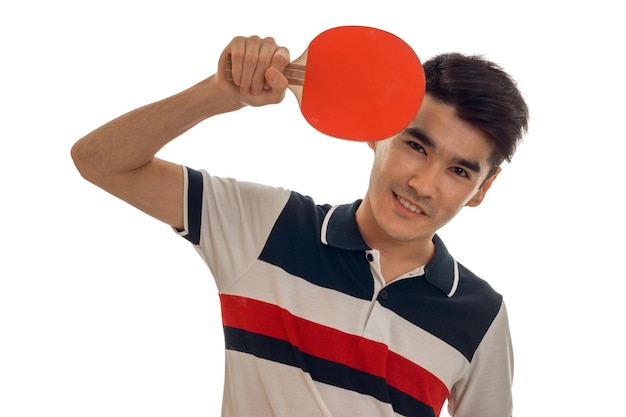 Photo cheerful young brunett sportsman practicing ping-pong isolated on white background