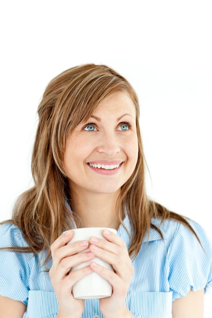 Cheerful young businesswoman holding a cup of coffee 