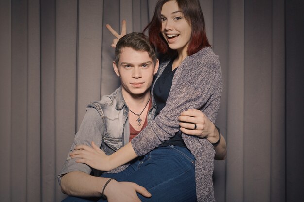 Cheerful young couple having fun and posing together