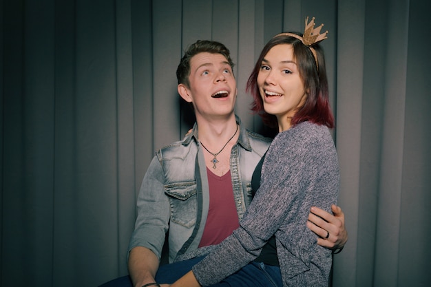 Cheerful young couple having fun and posing together