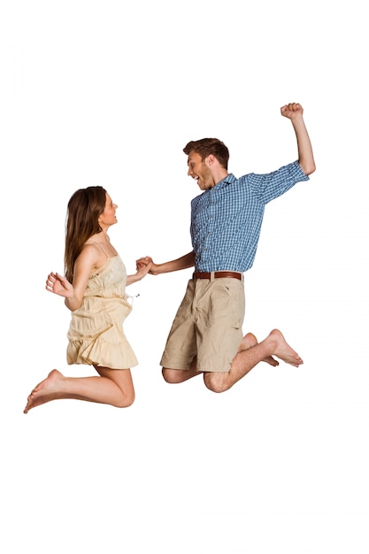 Photo cheerful young couple jumping