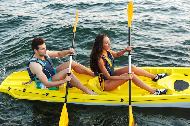 Cheerful young couple kayaking