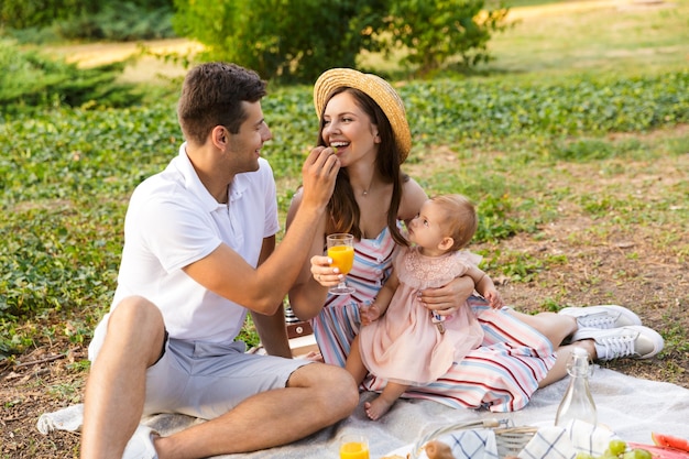 Cheerful young family with little baby girl