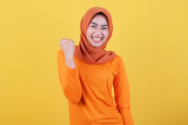 Cheerful young female has positive expression, has overjoyed look, being in high spirit, dressed casually wearing hijab