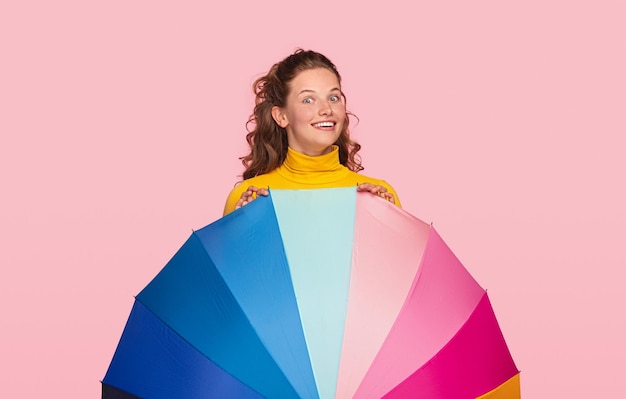 Cheerful young female with colorful umbrella