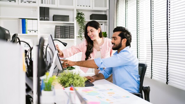 Photo the cheerful young group of asian businessmen in casual with an indian sitting and businesswoman