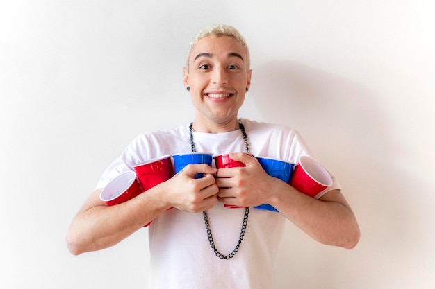 Cheerful young man holding cups