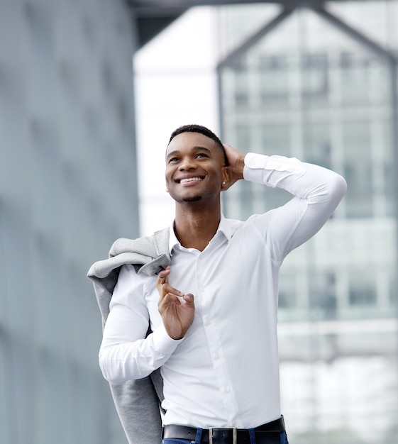 Cheerful young man smiling with white shirt