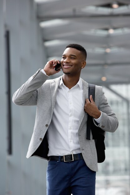 Cheerful young man talking on mobile phone