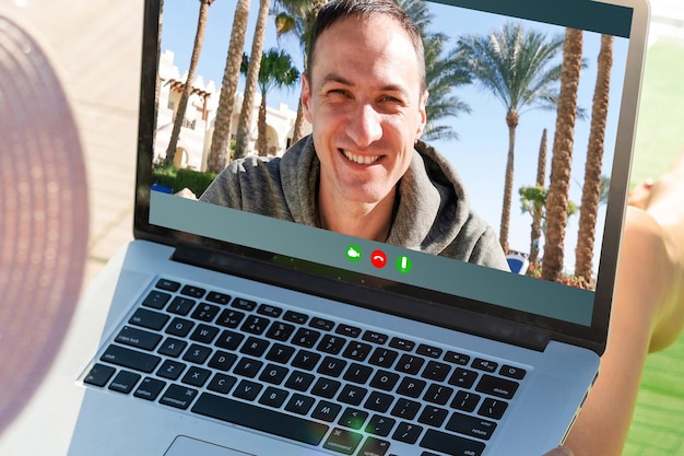 Cheerful Young Man Working Remotely from the beach With Laptop.