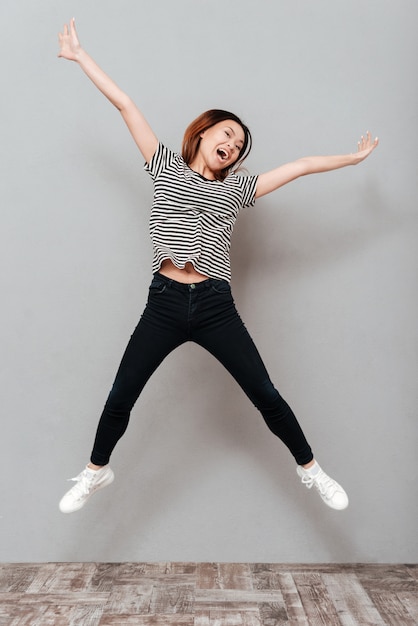 Cheerful young pretty woman jumping