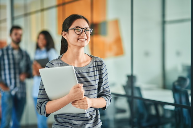 Cheerful young woman feeling happy while going to work