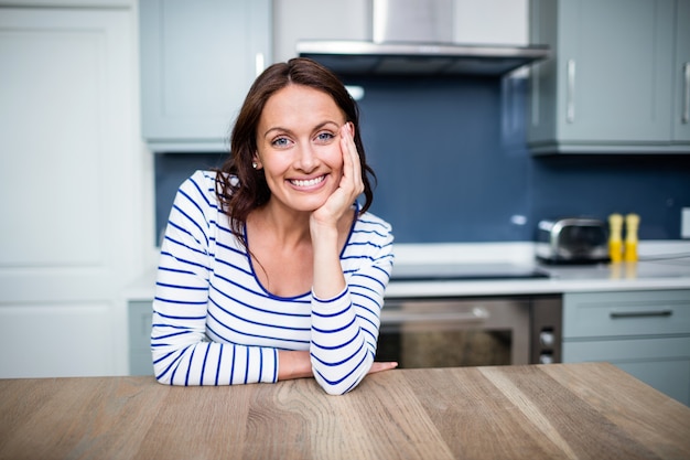 Cheerful young woman sitting at table