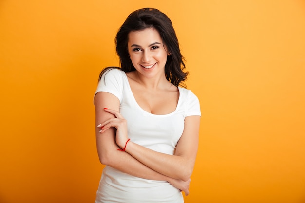 Cheerful young woman standing isolated