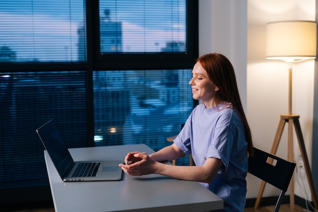 cheerful young woman talking to camera video calling conference with business partners