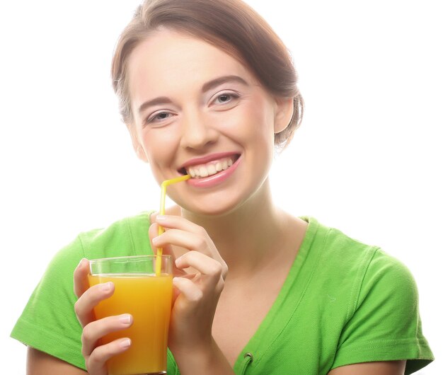 Cheerful young woman with orange juice, isolated on white