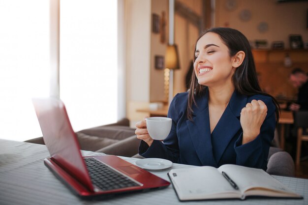 Cheerful young woman work in restaurant.