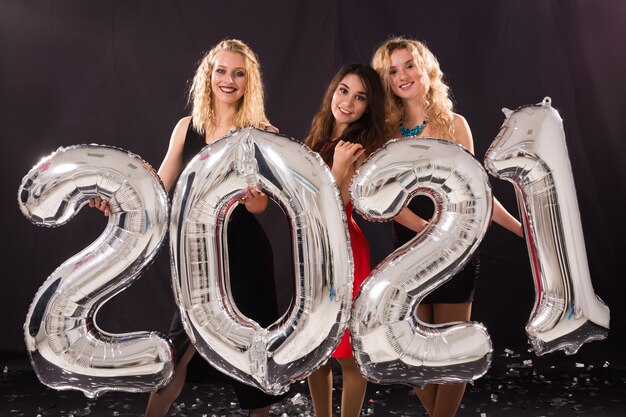 Cheerful young women celebrating new year