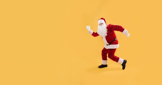 Cheerfully Santa in funny pose isolated