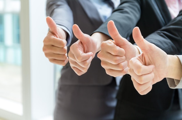 cheering business people holding many thumbs thumbs up