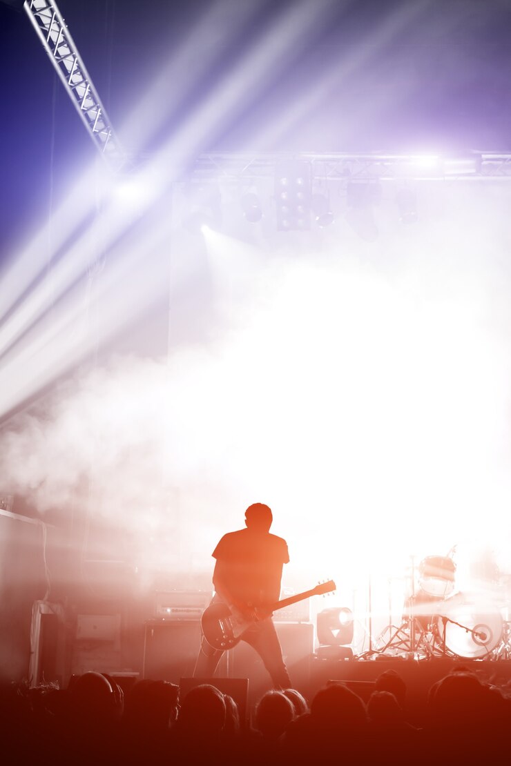Photo cheering crowd at a rock concert hand with sign of the horns