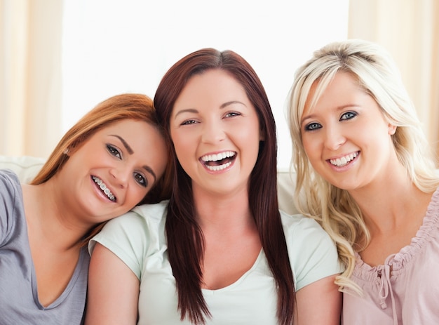 Cheering women sitting on a sofa