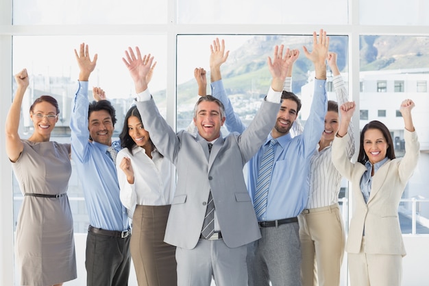 Cheering workers with raised arms