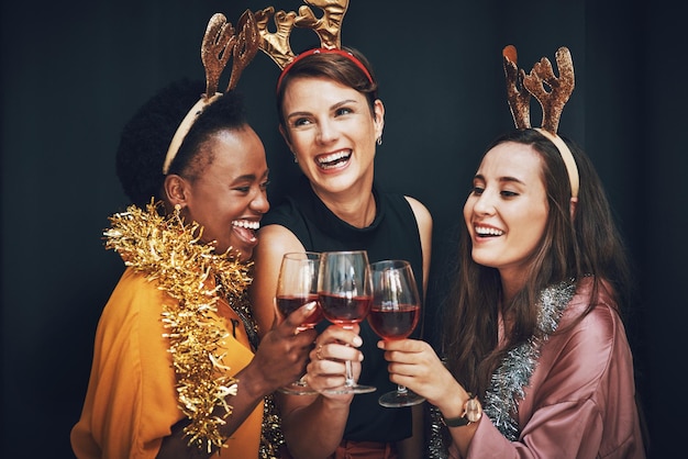 Cheers to the best friends life could give Cropped shot of a diverse group of friends standing and holding wine glasses for a toast at New Years