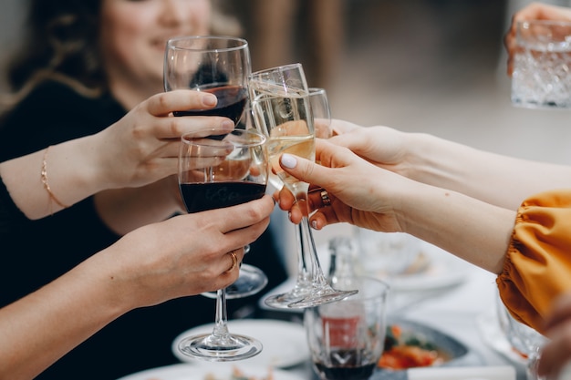 Cheers! Group of people cheering with champagne flutes with home interior