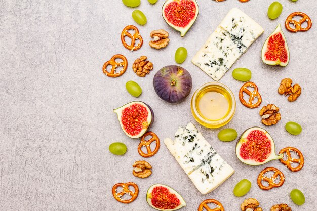 Cheese appetizer selection or wine snack set. Blue cheese, figs, honey, walnuts, pretzels